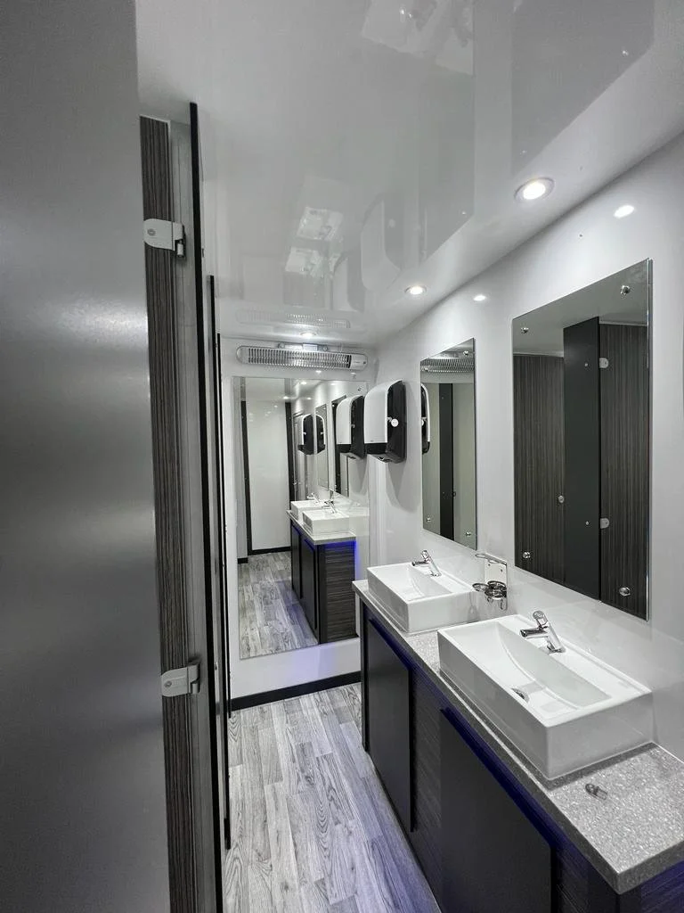 Luxury trailer interior hallway with sinks and mirrors